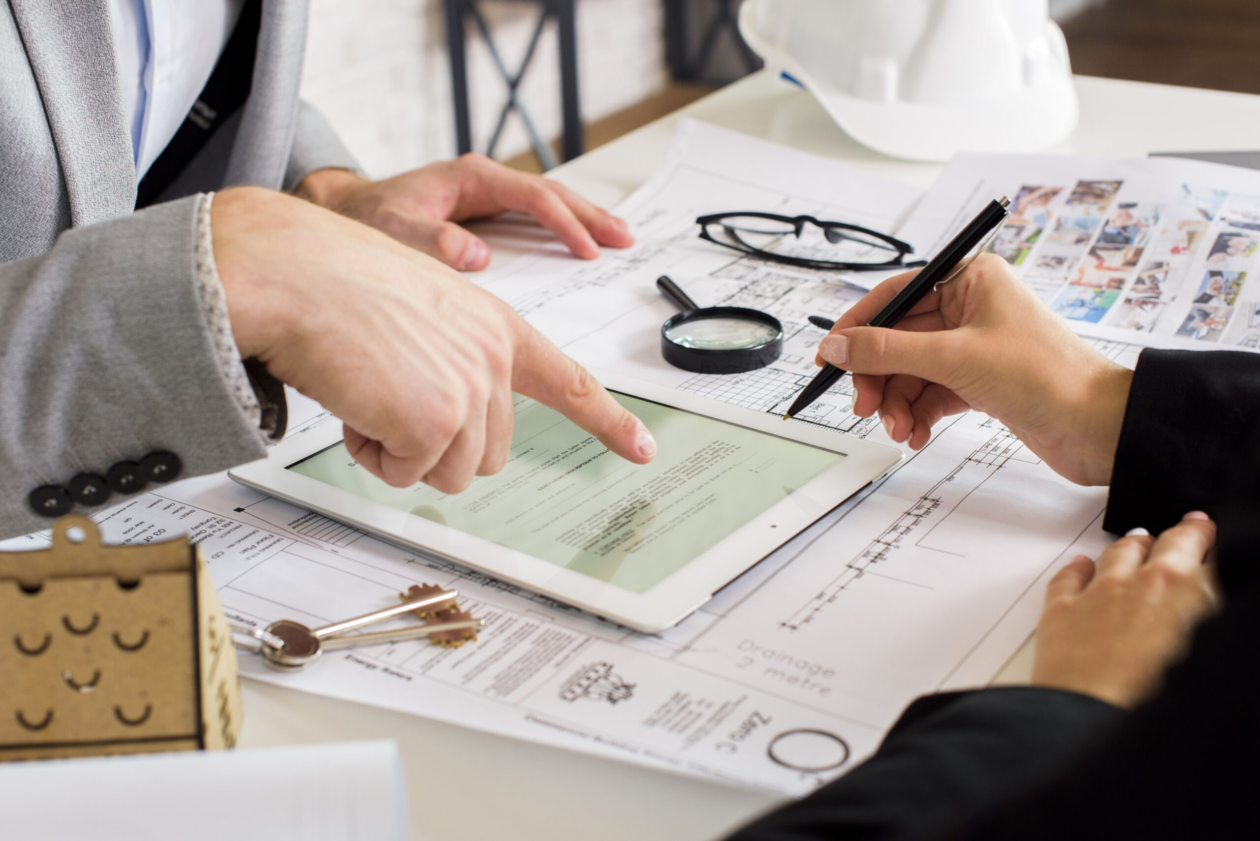Two professionals reviewing a tenant application during screening