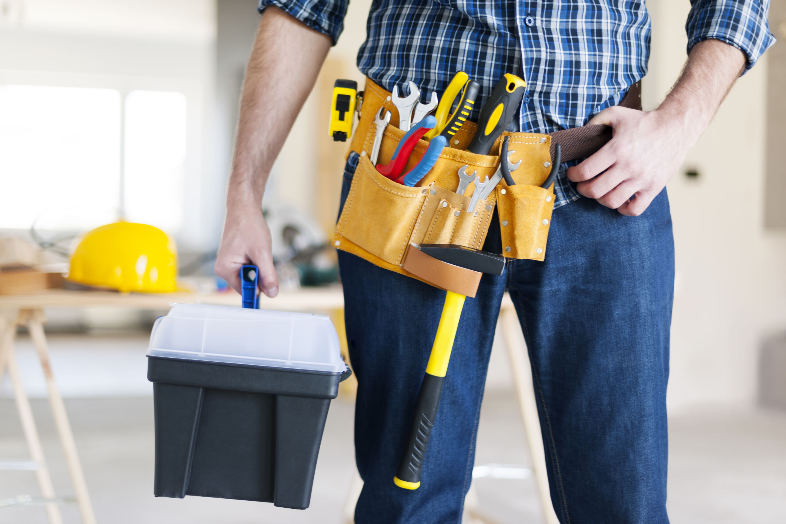 Male construction worker performing property repairs